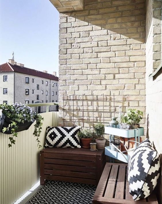 crates as seats and storage, a Raskog trolley by IKEA and some planters with greenery