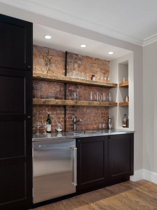 basement bar with a brick backsplash and open shelving