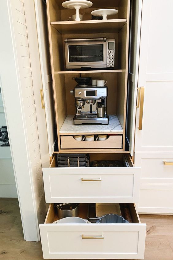 a cabinet with appliances and drawers and various tableware is a stylish solution for any kitchen