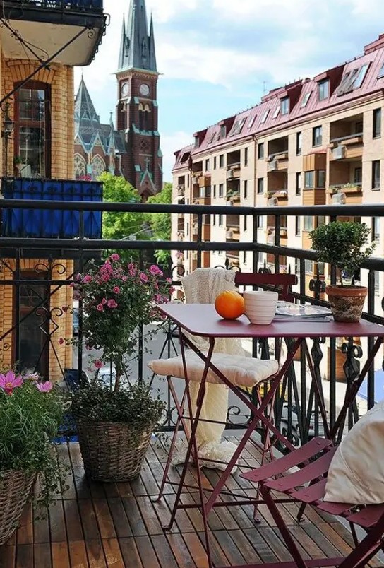 a chic and fun summer balcony with pink metal furniture, potted greenery and blooms is a simple and chic space to enjoy fresh air