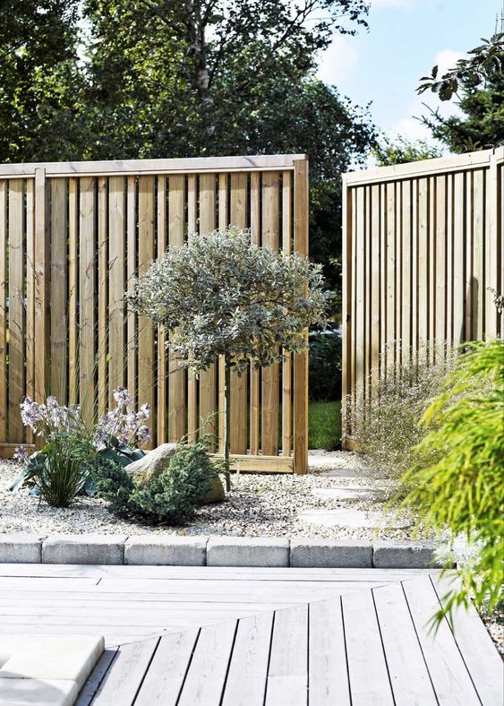 a classy modern light-stained wooden fence with a seamless gate is a perfect solution for a contemporary space