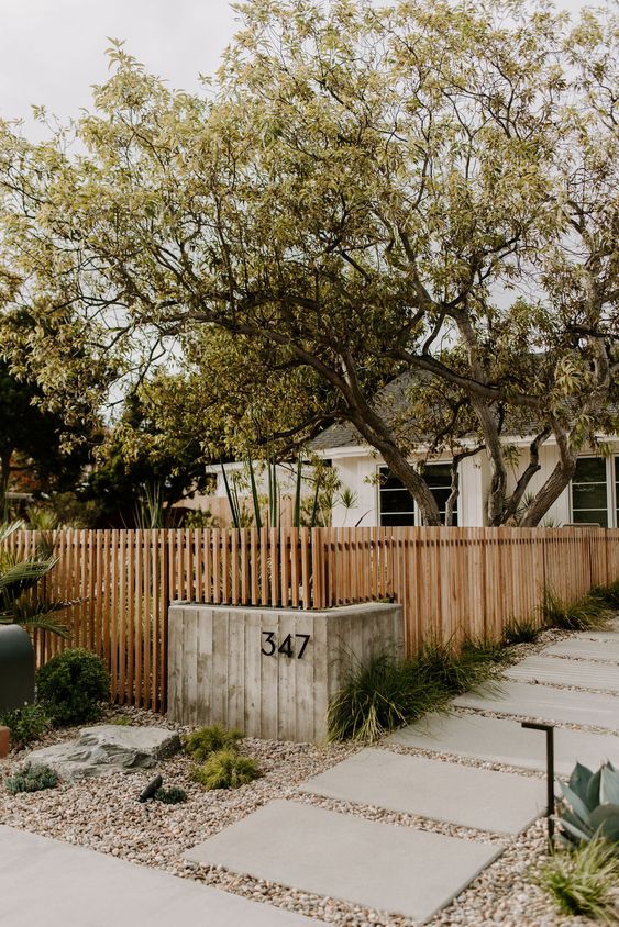 a classy modern stained wooden fence is always a good idea for a modern front or backyard