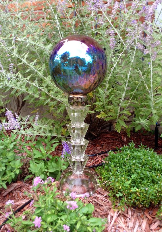 a colorful garden ball will illuminate and spice up any garden space, even the simplest and smallest one, put it on a stand to make it clearly seen