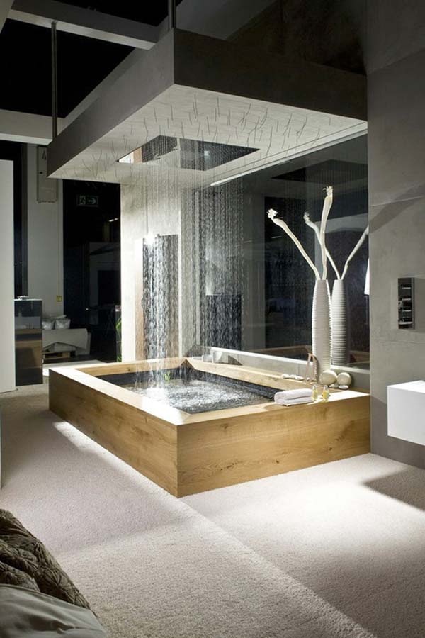 a contemporary bathroom with a rectangular-shaped bathtub and a large rain shower over it plus built-in lights