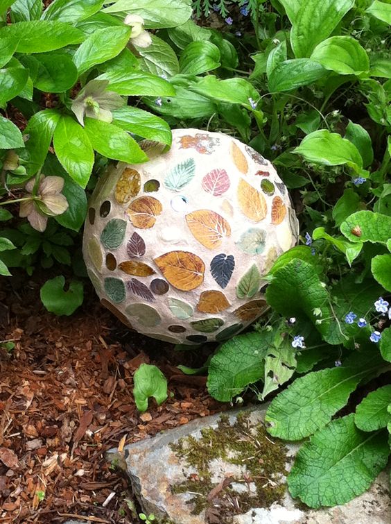 a creative take on a garden ball highlighted with colorful leaves is a great idea, and it can be DIYed