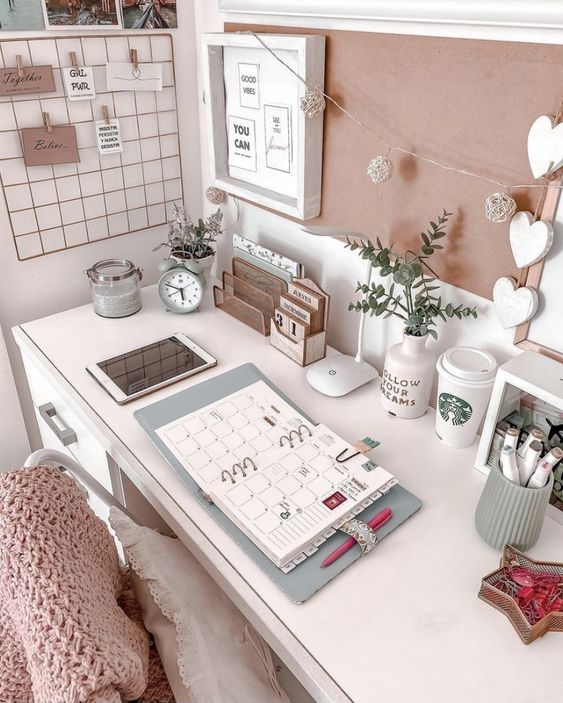 a cute and chic workspace with a desk and a chair, some decor and accessories, some cool storage and a grid with memos plus lights