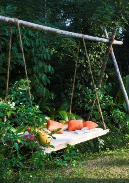 a DIY swing in the greenery, with bright pillows will be a great space to have a rest outdoors