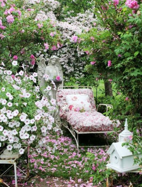 a dreamy secret garden nook with blooming trees and just flowers, a vintage lounger and a statue is wow
