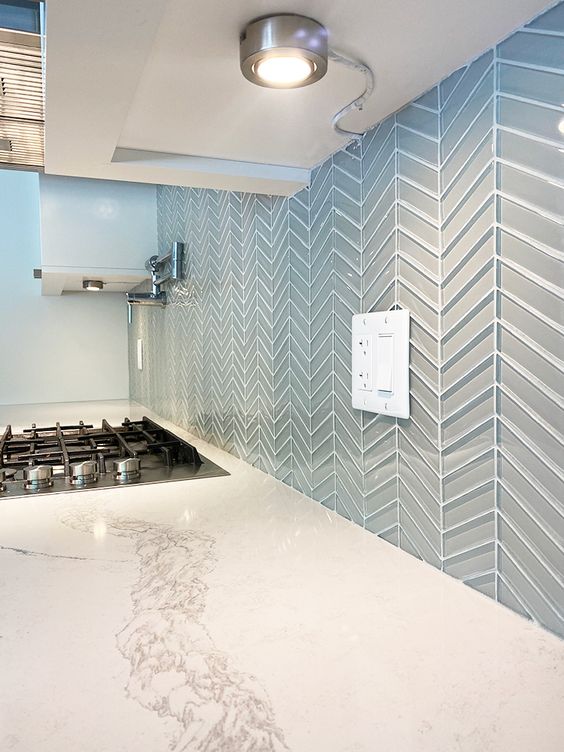 a glossy blue glass tile backsplash is semi sheer and very beautiful, it will add a subtle touch of color to the kitchen