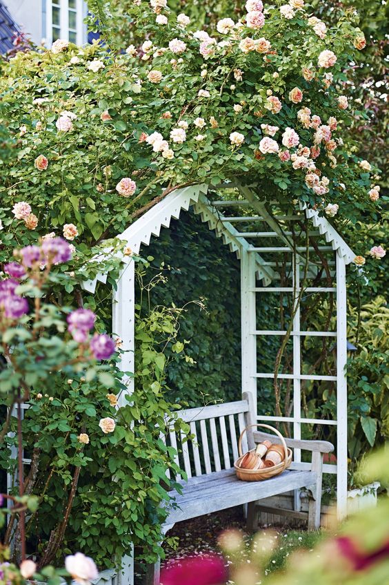 a jaw-dropping floral arch that creates intimacy and a cozy feel and a bench under it for a secret garden feel