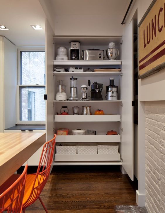 a large storage unit with shelves and drawers, with various appliances and other stuff is a cool idea to hide everything