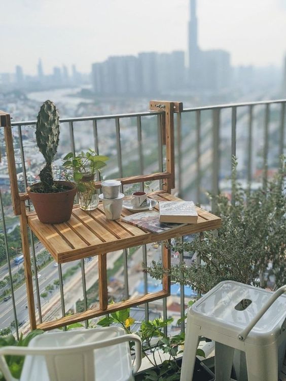 a little wooden folding table that can be hung on the railing is a brialliant idea for a tiny or small balcony and it looks eco-friendly and natural