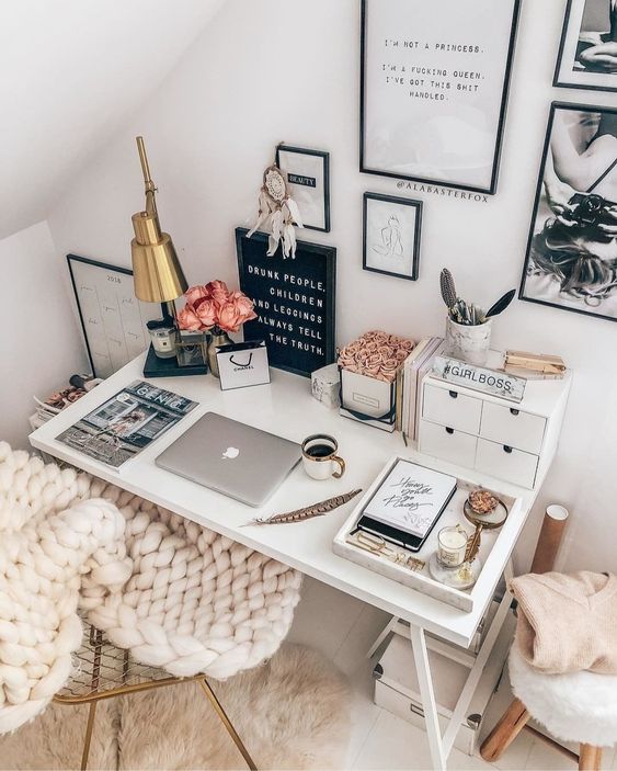 a lovely Scandinavian workspace with a desk, a chair, a gallery wall, some decor, a table lamp and cool accessories