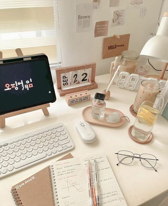 a neutral aesthetic workspace with a desk, some devices, wooden accessories, decor and some memos right on the wall