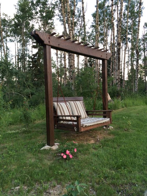 a rich-stained frame and a swinging chair on chain is a super cool item for a garden or outdoors