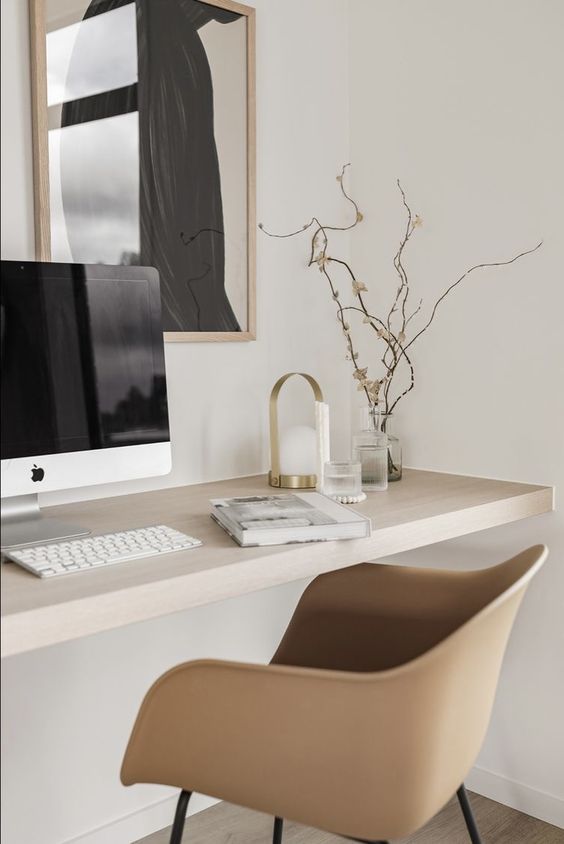 a Scandinavian workspace with a wall-mounted desk, a chair, some chic decor and an artwork is a great nook to work in