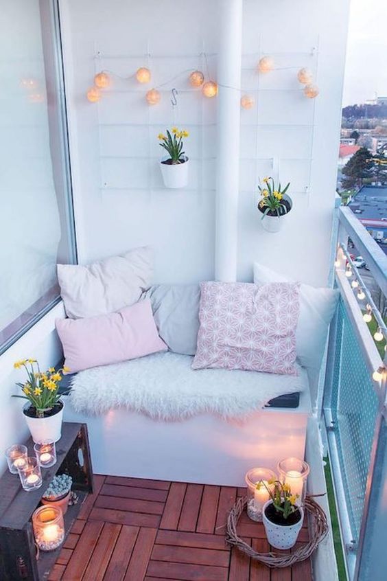 a sleek white bench with storage space inside and a small crate shelf next to it for more storage