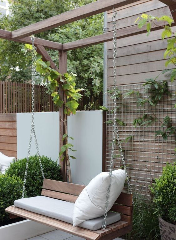 a small and minimal stained bench hanging on chain is a creative alternative to a usual chair or outdoor armchair