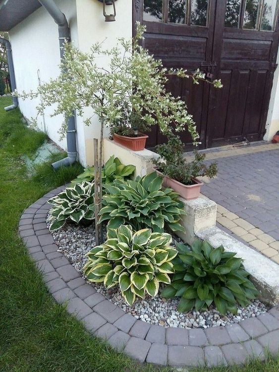 Rocking small plants around a tree always looks great and could add interest to your front porch.