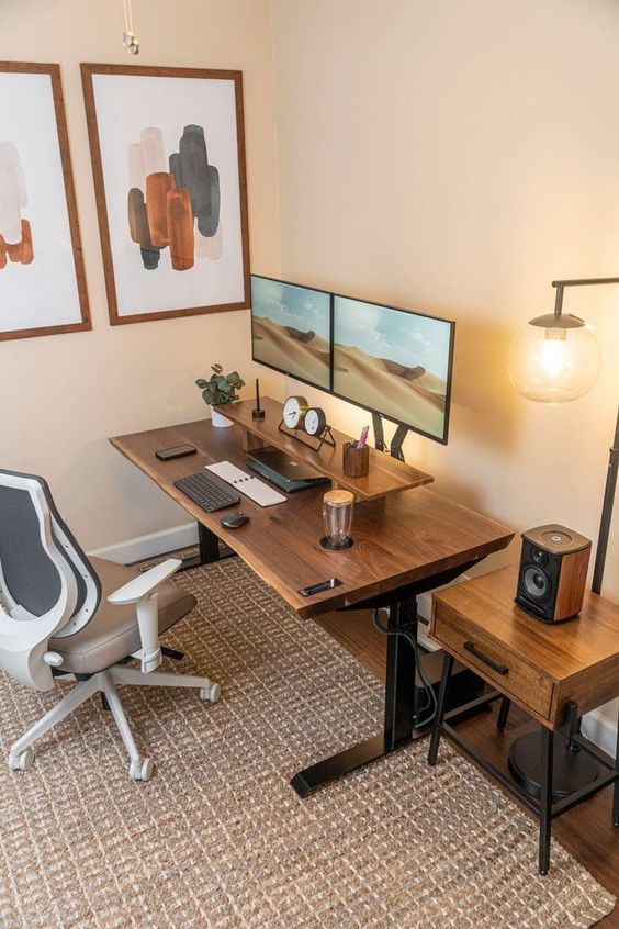 a stylish workspace with a desk and a stand, a side table, a gallery wall, a chair and a lamp is amazing