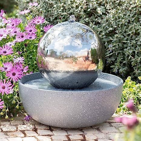 a terrazzo bowl with a mirror sphere fountain is a unique water feature that is portable and looks very cool
