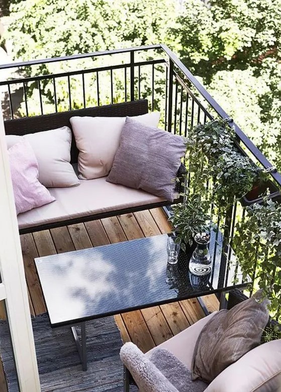 a tiny space with a bench, a coffee table and a chair with some pillows as a comfy eating space