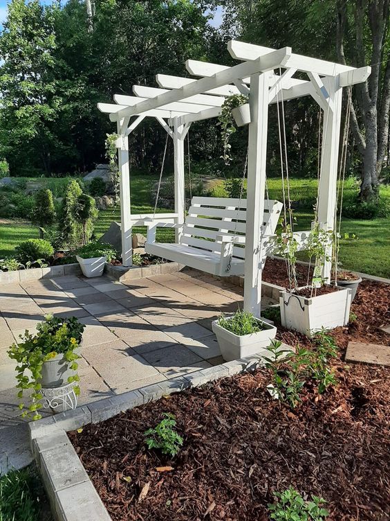 a white arbor paired with a pendant bench is a classic idea for outdoors, it will match a rustic or cottage space