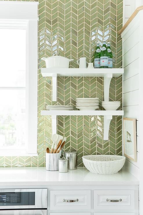 a white modern farmhouse kitchen with a green chevron tile backsplash and white shelves is a stylish and cool space