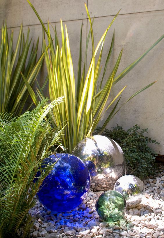 an arrangement of silver, blue and grey garden balls is a lovely decoration for a modern garden