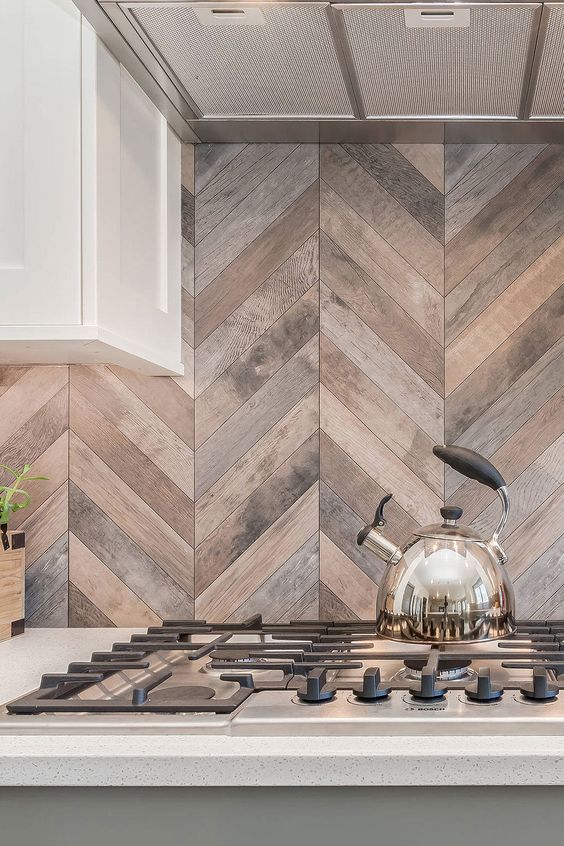 an olive green and white kitchen with a stained wood chevron tile backsplash and built-in lights is amazing