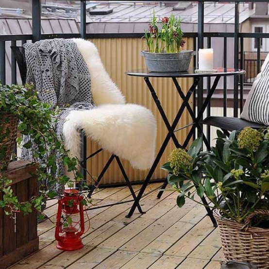 spring bulbs in a bucket and some greenery in baskets around are a cool and fresh way to make your balcony feel like spring