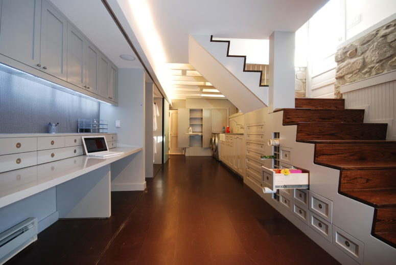 Thoughtful cabinetry could not only provides a lot of space for storage but also turn the basement into a fully functional arts and crafts room. (E/L STUDIO)