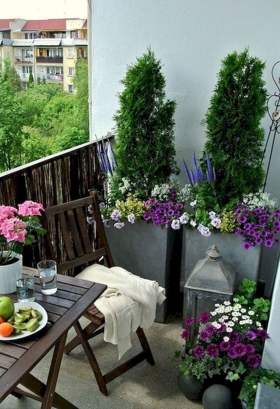 bright potted blooms and greenery and some simple garden furniture are amazing for a springy feel