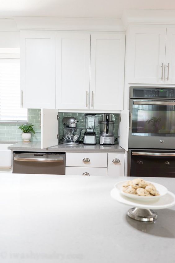 built-in doors make this part of countertop a little cabinet for hiding appliances inside and decluttering the kitchen