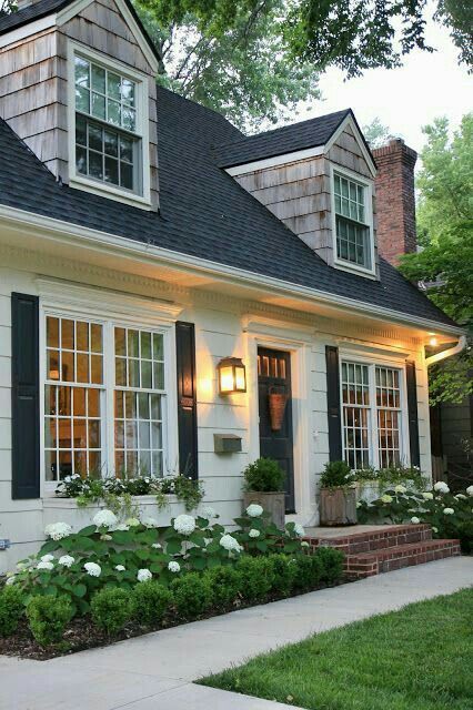Classic garden beds on both sides of the porch, with white hydrangeas is a classic idea that perfectly matches the look of the cottage annd enlivens the front yard.