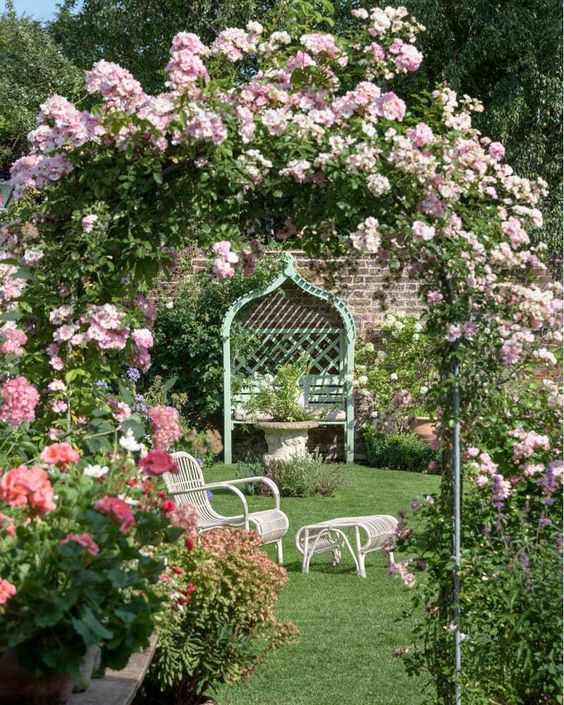 create an entrance to some part of your garden rocking a metal arch covered with pink blooms and greenery
