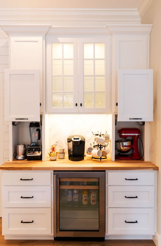 mini cabinets with sliding doors and with appliances hidden there plus a coffee station in the center is a stylish idea