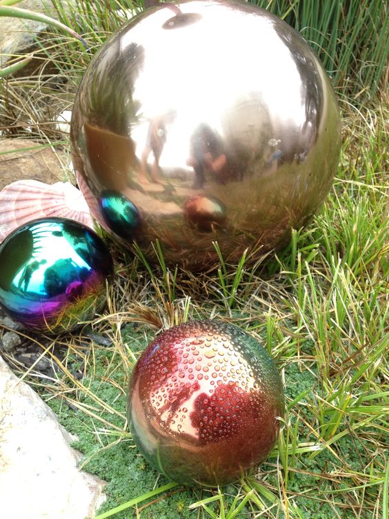 mismatching gazing balls on the grass will be a great alternative to blooms and any greenery, these are creative decorations