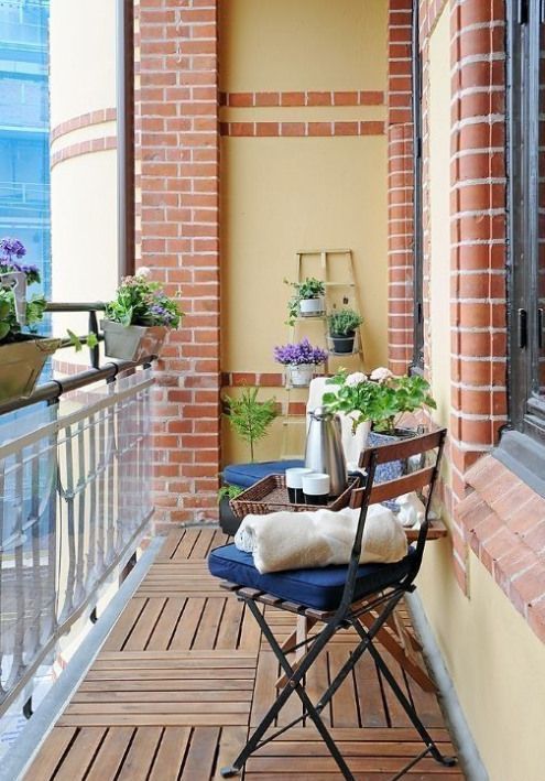 potted greenery and blooms and some usual garden chairs with cushions are nice for a spring outdoor space