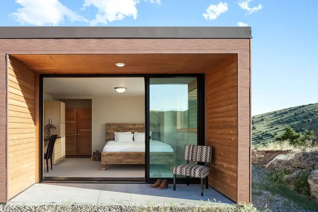 View of a bedroom with large glass sliding doors as viewed from the outside looking in