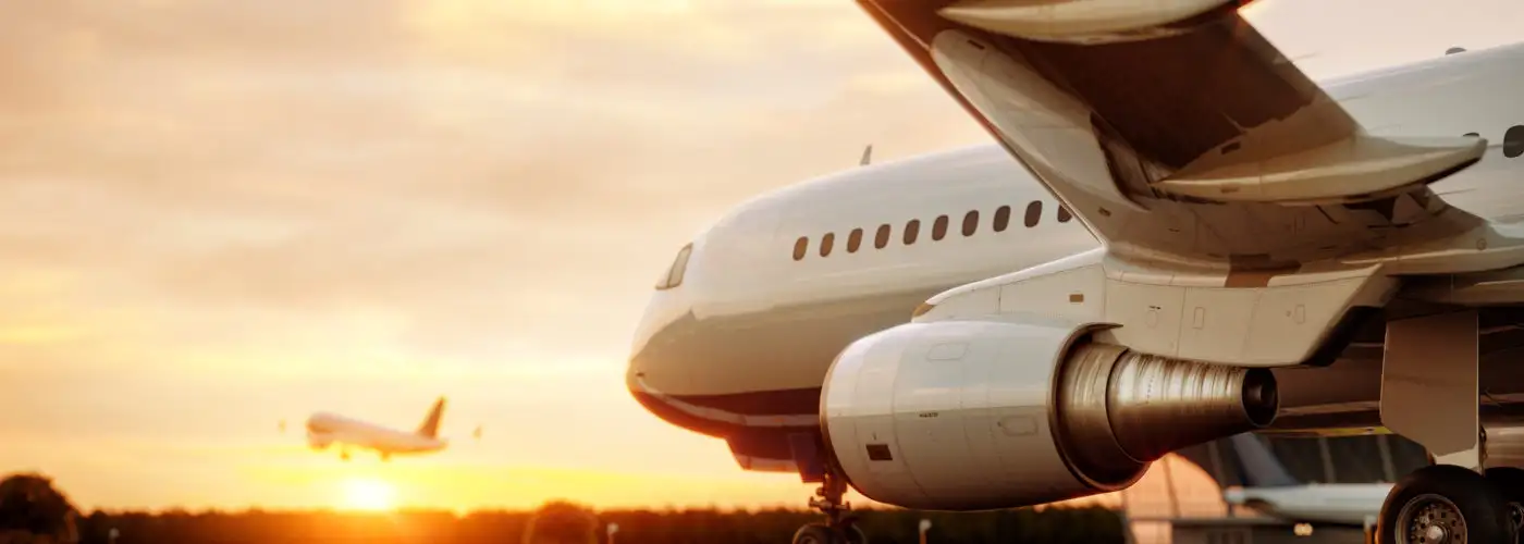 Airplane on tarmac at sunset