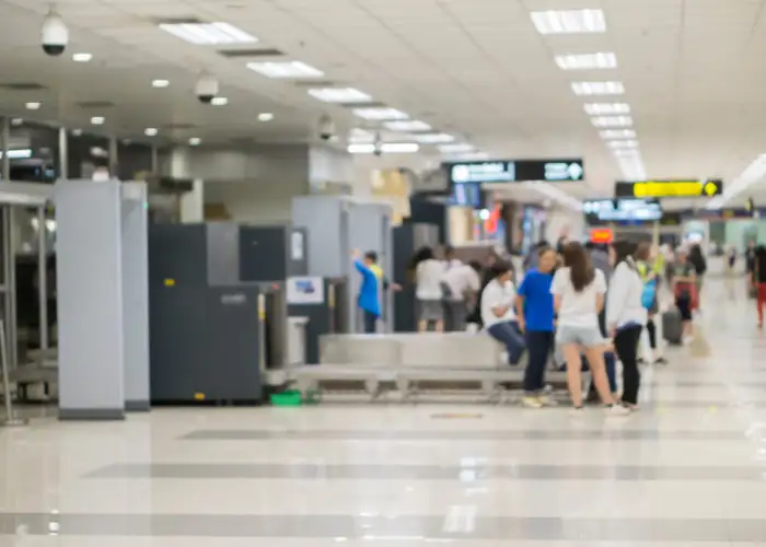 People waiting in line at airport security