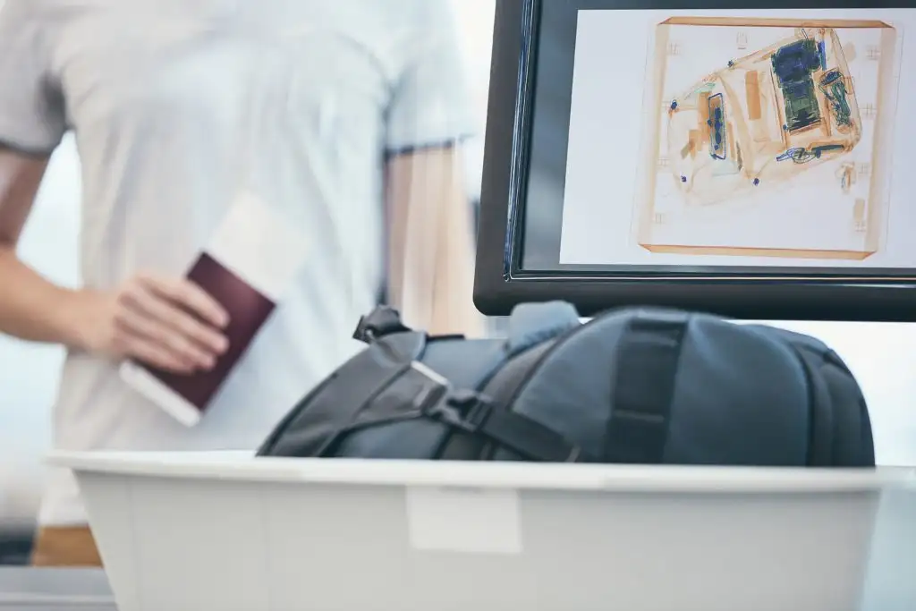 Close up of carry on backpack as it goes through a security scanner