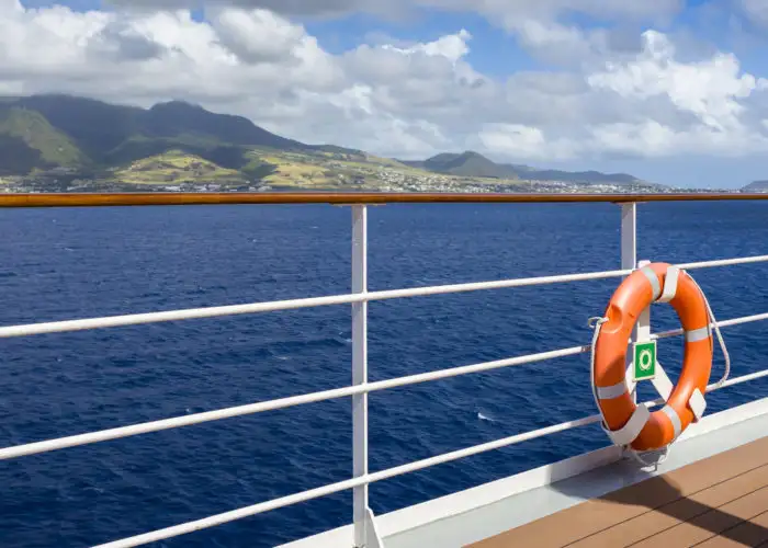 Life preserver hung on the railing on a cruise ship deck