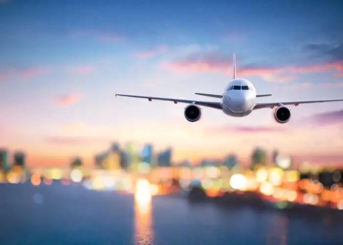 Airplane landing on runway at dusk