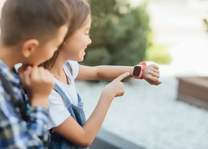 Two children looking at a smartwatch