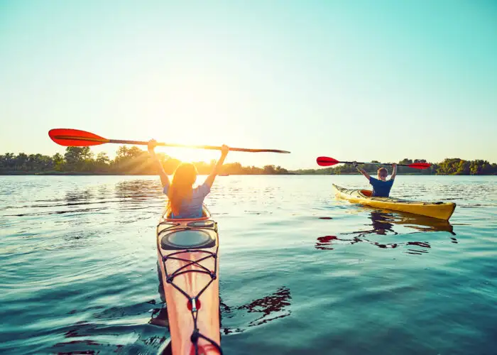 Two people kayaking at sunset