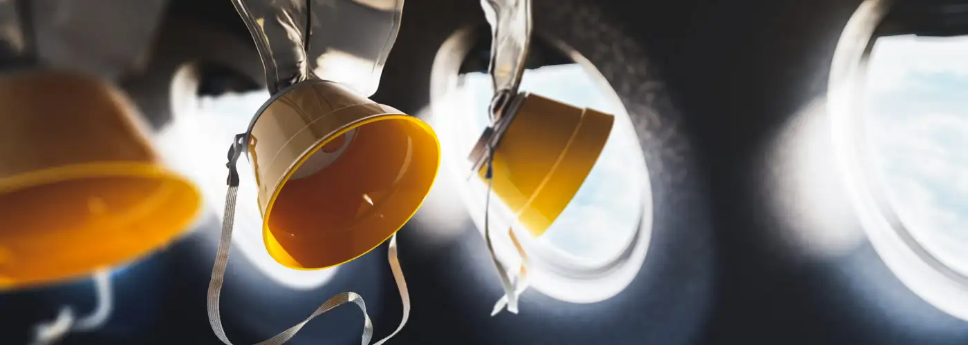 Oxygen masks on plane hanging from ceiling