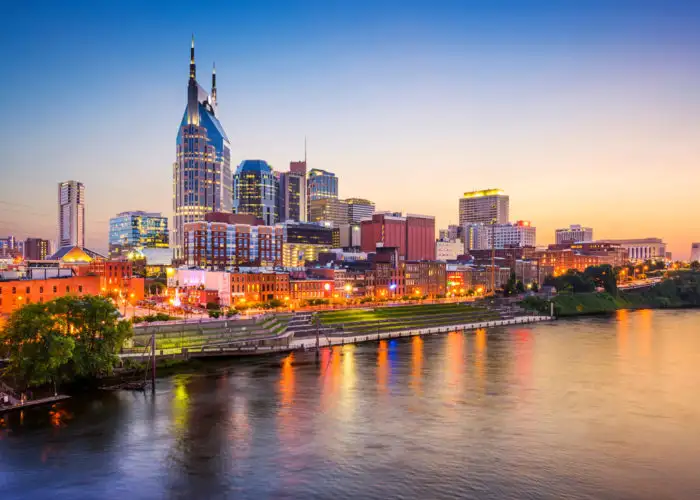 Skyline of Nashville, Tennessee by the water at sunset