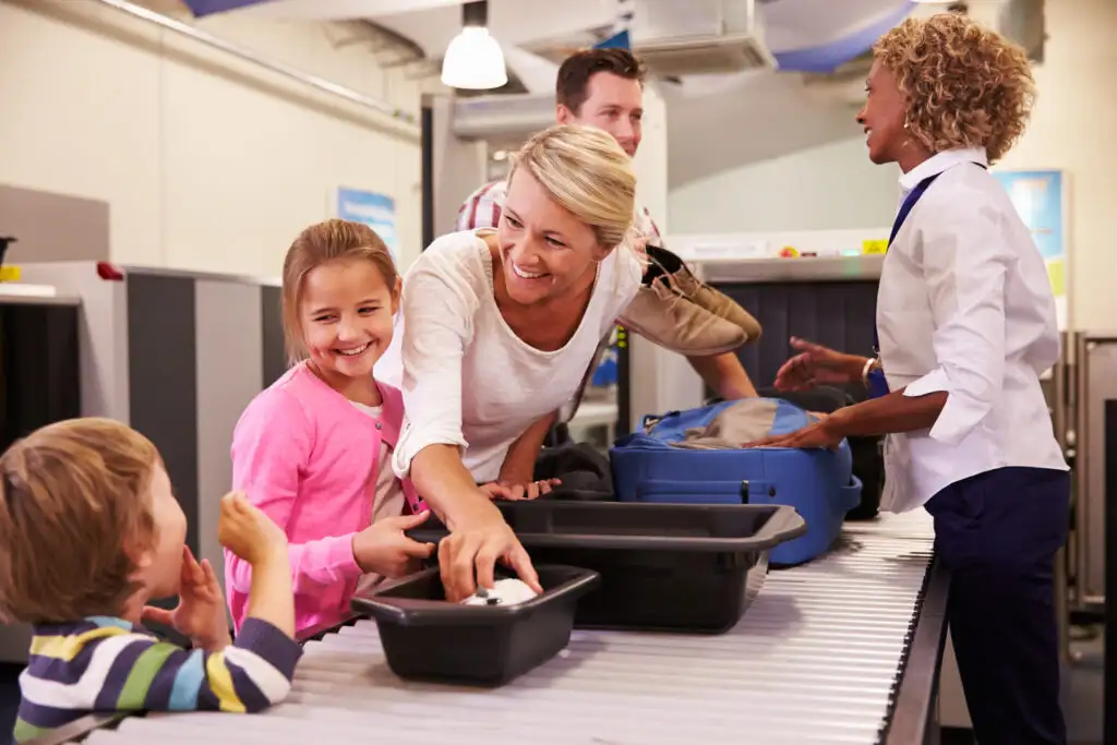 Family going through security scanner line at airport